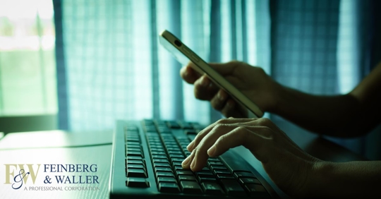 person on a phone and keyboard