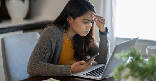 A woman reviewing her finances on her computer