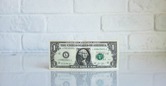 A one-dollar bill sitting on a counter