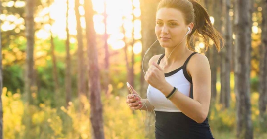 A woman running in a wooded area