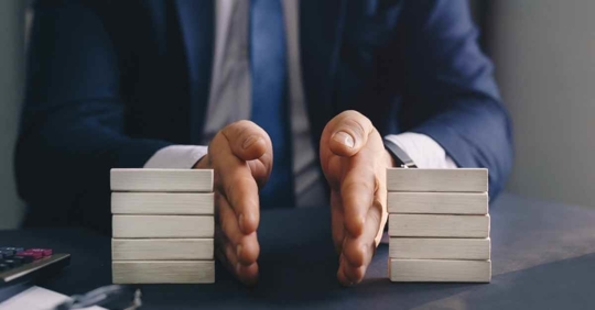 A man in a suit dividing some blocks in half