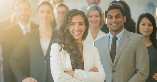 A group of men and women wearing professional attire