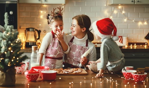 mother and children baking cookies during the holidays