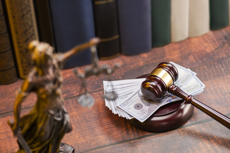 money under a gavel in a law office