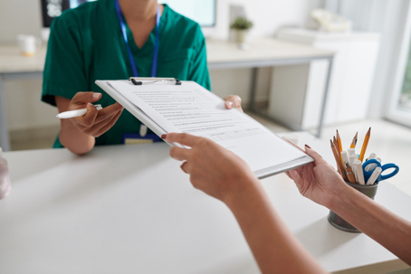 Patient giving doctor signed forms