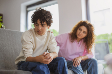 upset boy refusing to look at mother