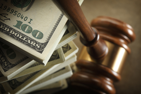 a stack of cash and a gavel