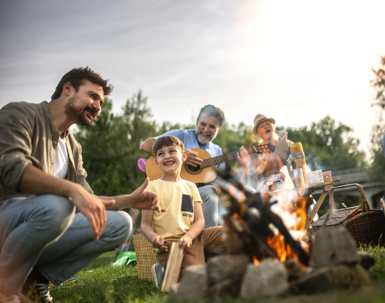 multigenerational family seated around a bonfire