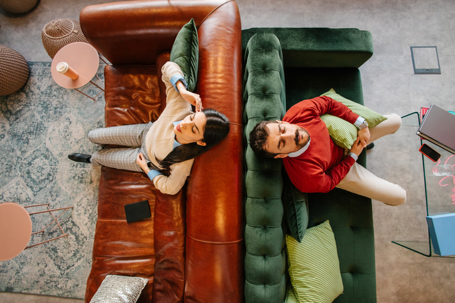 stressed couple sitting on separate couches
