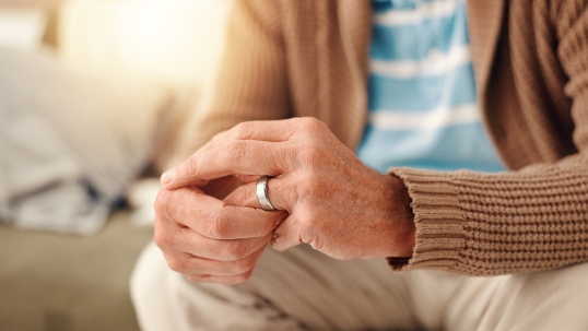 Senior man removing his wedding ring