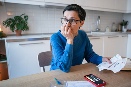 stressed woman calculating expenses